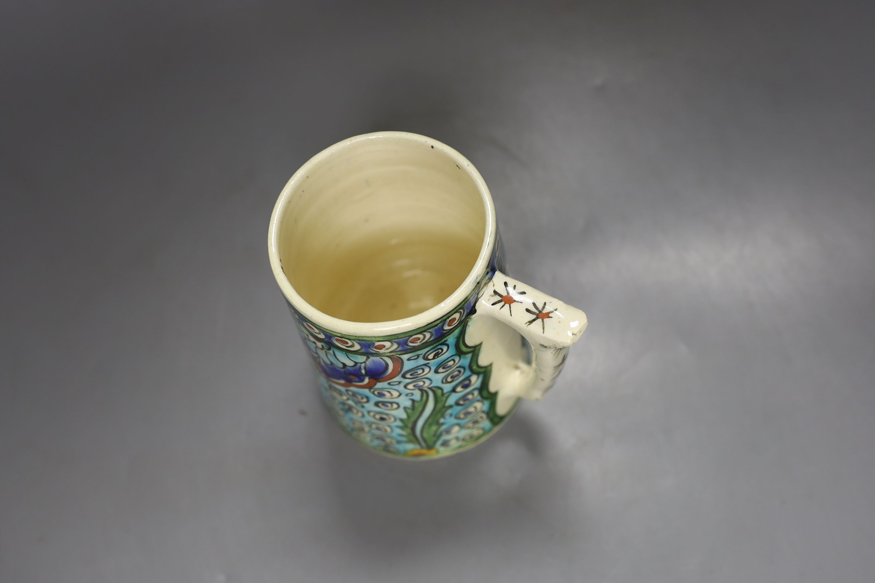 A Turkish Kutahya earthenware tapering mug, 12.5 cm high